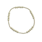 Gold filled patterned beaded stretch bracelet with mixed bead sizes.