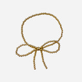 Gold filled beaded bracelet with delicate bow design and stretch fit.