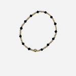 Gold and coal crystal beaded bracelet with patterned stretch design.