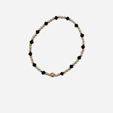Gold and coal crystal beaded bracelet with patterned stretch design.