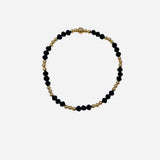 Gold and coal crystal beaded bracelet with mixed patterned stretch design.