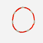 Gold filled bracelet with orange beads, pearl accents, and stretch fit.