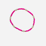 Gold filled bracelet with pink beads, pearl accents, and stretch fit.