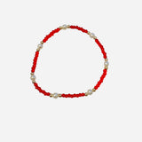 Gold filled bracelet with red beads, pearl accents, and stretch fit.