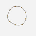 Mixed metal bracelet with sterling silver and gold filled beaded pattern.