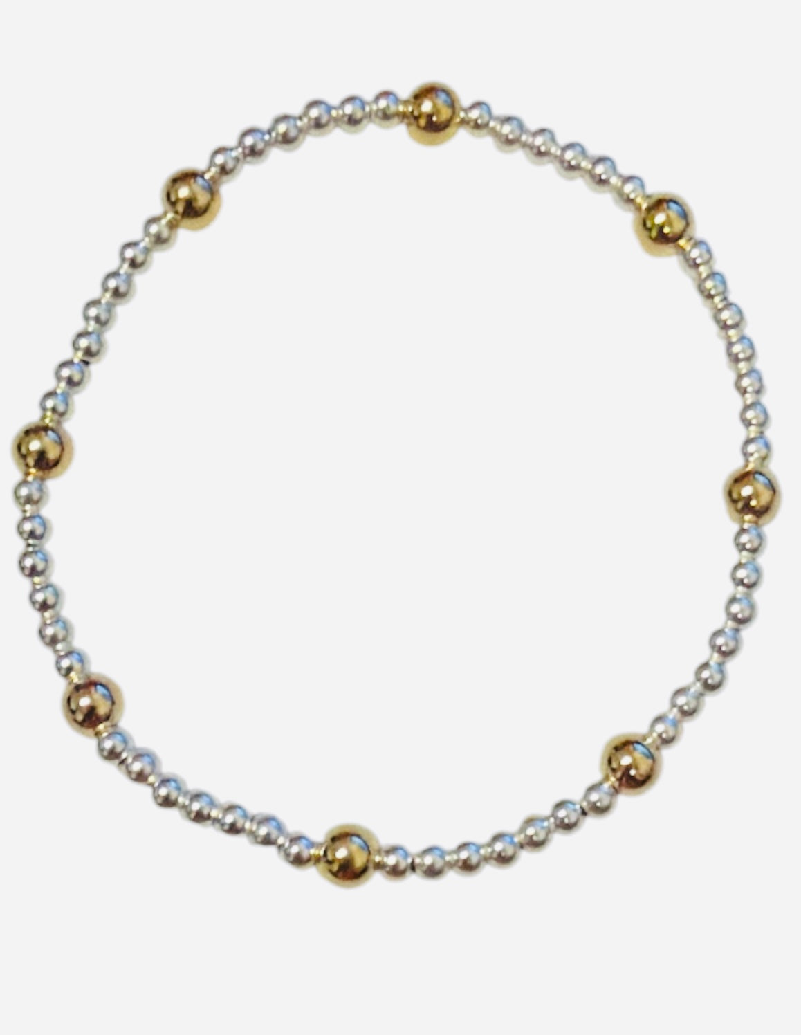 Mixed metal bracelet with gold-filled and sterling silver waterproof beaded design.