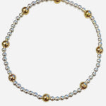 Mixed metal bracelet with gold-filled and sterling silver waterproof beaded design.