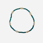 Gold filled bracelet with teal beads, pearl accents, and stretch fit.