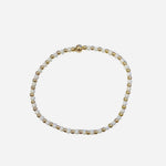Gold filled bracelet with white beads, pearl accents, and stretch fit.