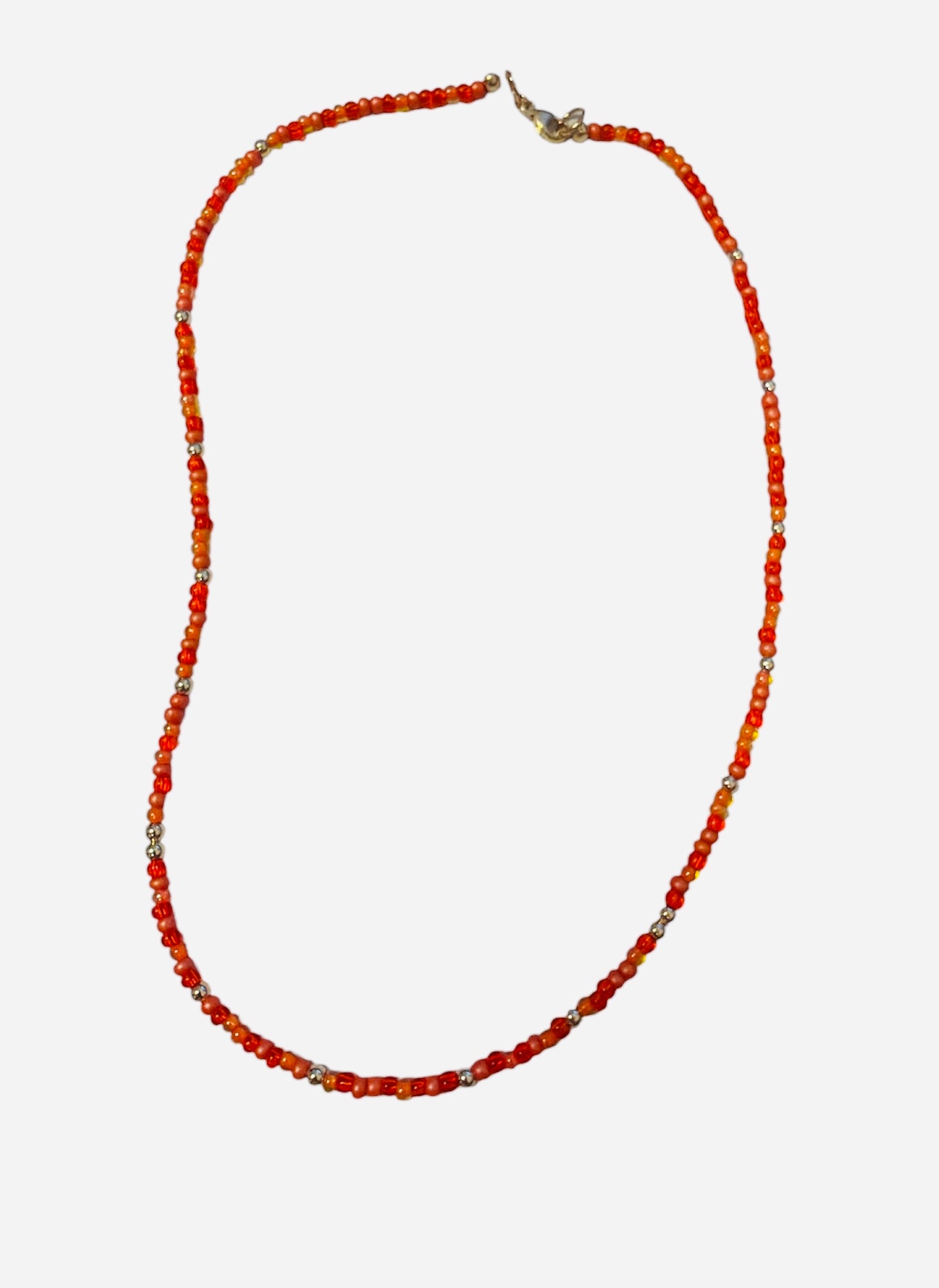 Gold filled necklace with orange beads and silver accent details.