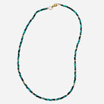 Gold filled necklace with green beads and gold accent details.