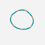 Gold filled bracelet with teal beads and pearls in stretch design.