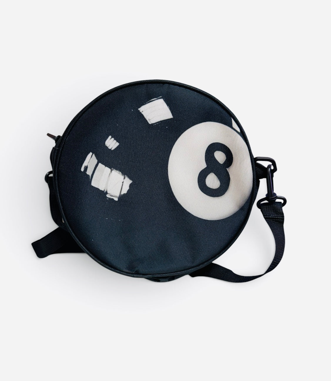 Round black 8-ball crossbody purse with adjustable strap.