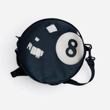 Round black 8-ball crossbody purse with adjustable strap.