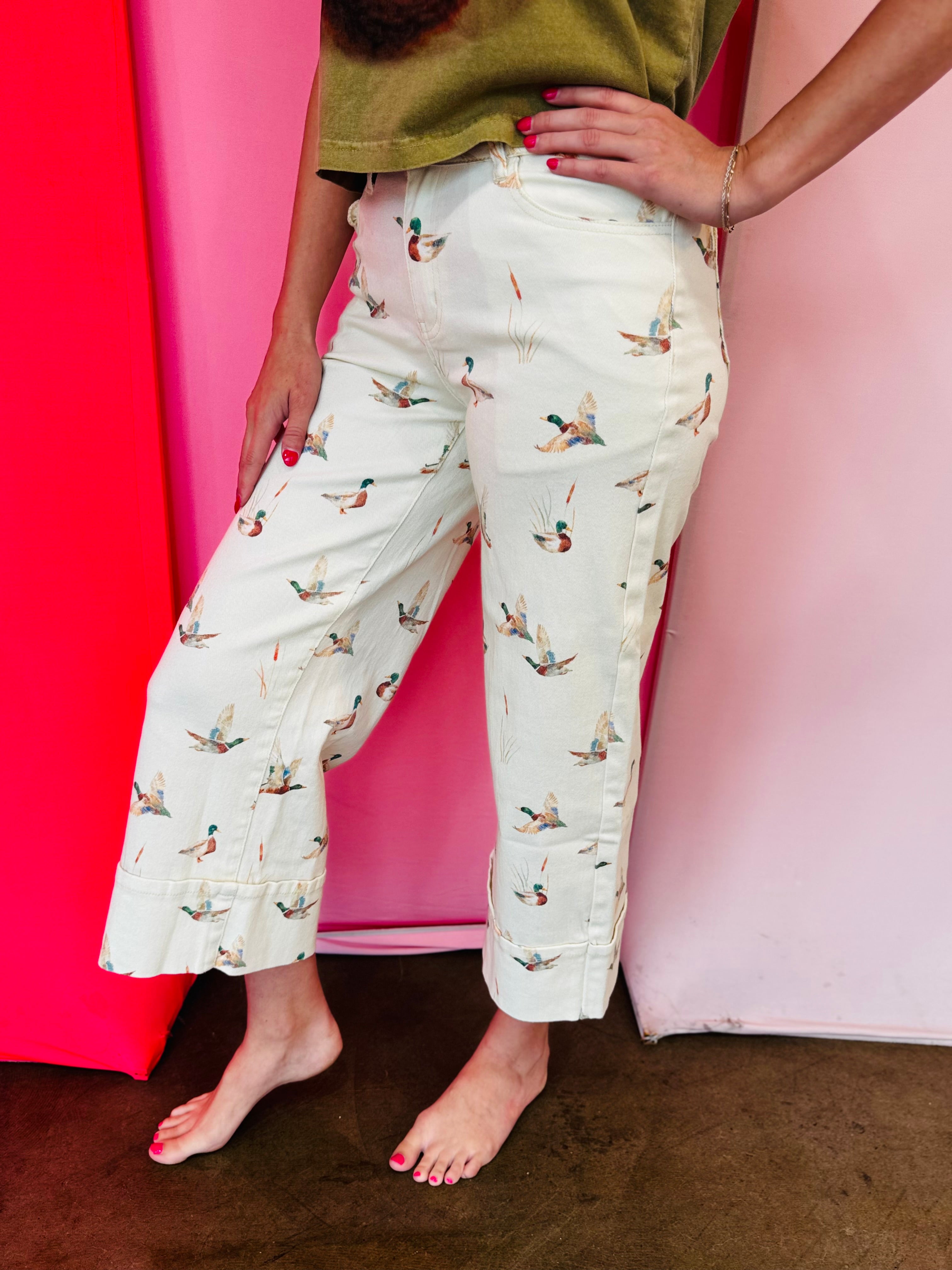 Beige cuffed pants with allover mallard duck print and relaxed fit