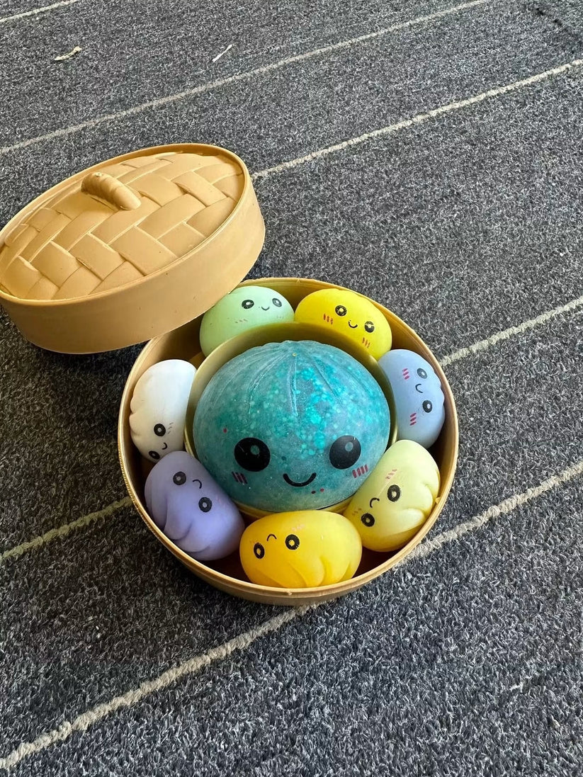 Mama dumpling with six colorful baby dumpling squishy sensory toys.