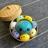 Mama dumpling with six colorful baby dumpling squishy sensory toys.