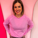 Mauve cotton raglan top with thumbhole cuffs.