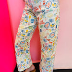 Mediterranean print flare pants with cropped fit and colorful stretch denim design.
