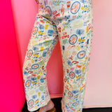 Mediterranean print flare pants with cropped fit and colorful stretch denim design.