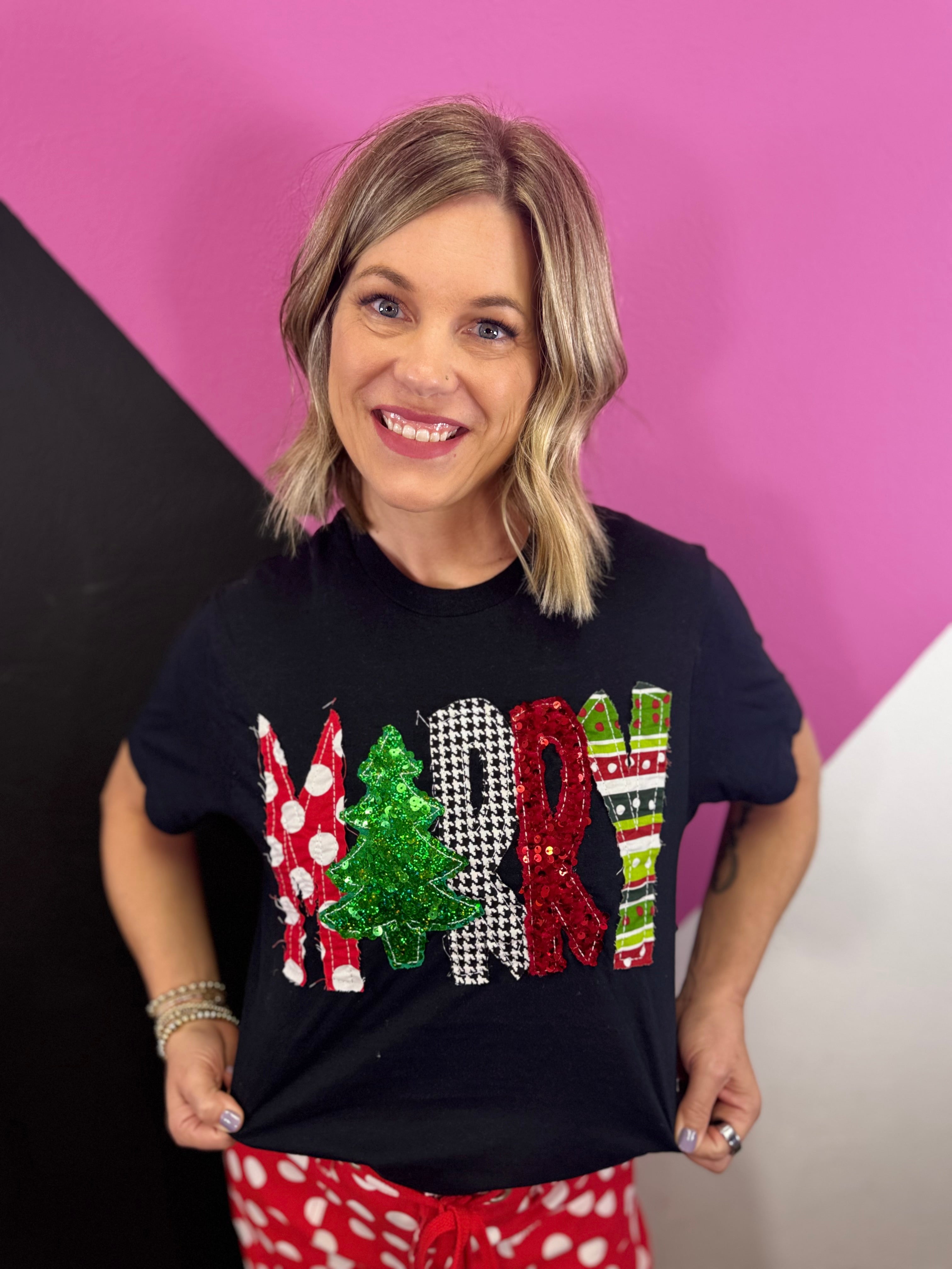 Black Christmas tee with patchwork Merry lettering and sequins.