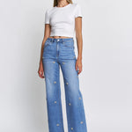 High-rise wide-leg jeans with rhinestone bow embellishments.