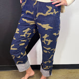 Green and black camo crop jeans with high-rise waist, straight leg, and wide rolled cuffs.