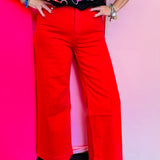 Red high-rise wide leg ankle jeans with structured waistband and flowy fit.