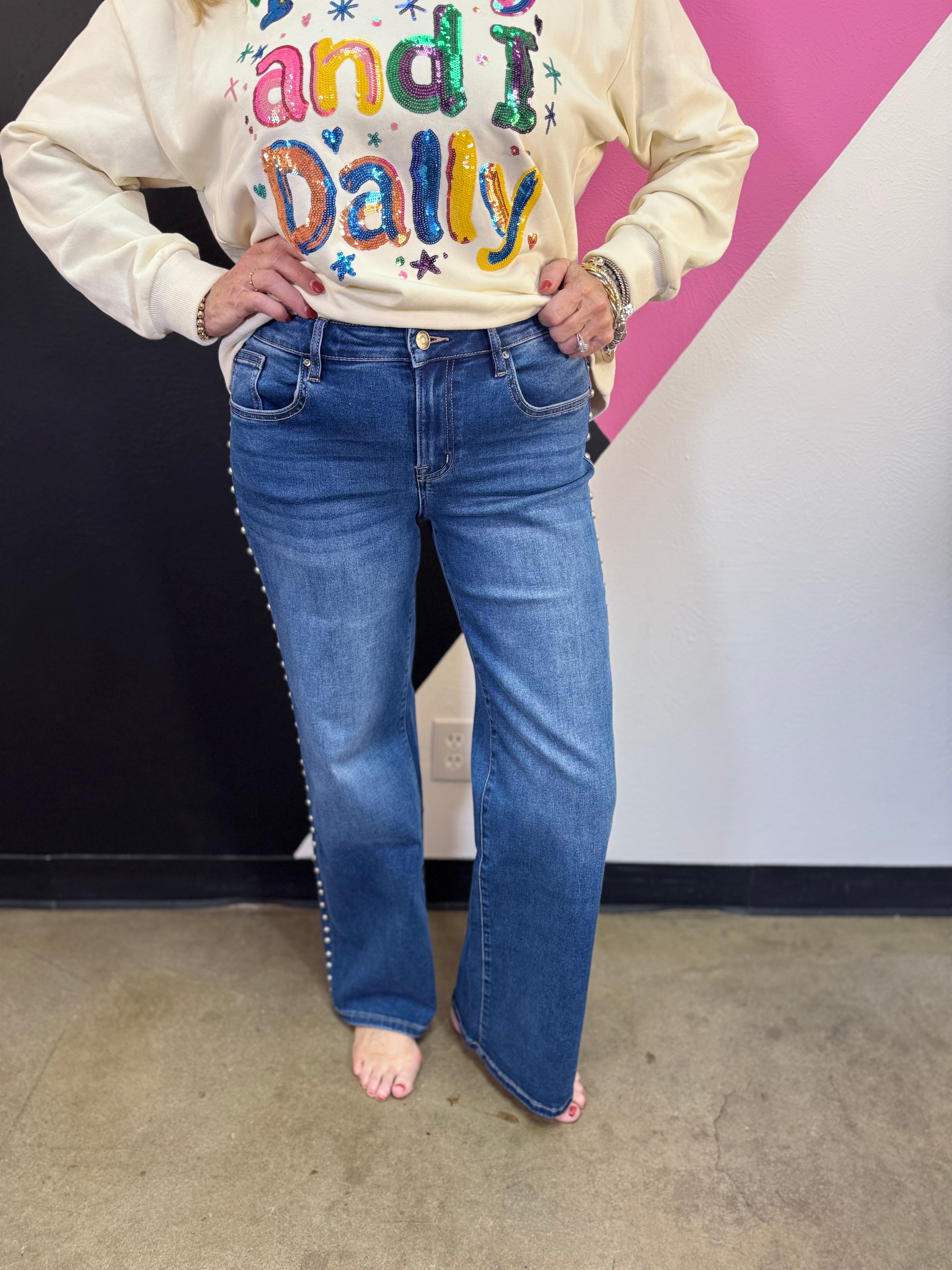 Denim wide-leg jeans with high-rise waist and statement stud detailing along the sides.