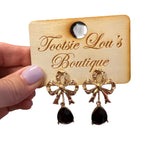 Gold bow stud earrings with glossy black teardrop gems for elegant, timeless style.