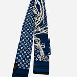 Navy blue twilly scarf with rope buckle and geometric print details.