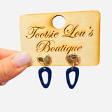 Hammered gold stud earrings with deep navy abstract drop shapes.