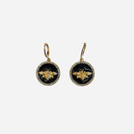 Black medallion earrings with crystal trim and gold bee accents.