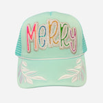 Mint trucker hat with colorful sequin “Merry” patch and white embroidered leaf accents on brim.