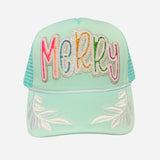 Mint trucker hat with colorful sequin “Merry” patch and white embroidered leaf accents on brim.