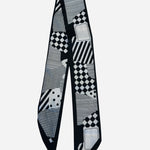 Black and white twilly scarf with geometric patchwork and checkerboard prints.