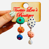Colorful asymmetrical rhinestone earrings with pearl, mint, coral, blue, and pink details