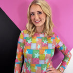 Sheer multicolor mesh top with patchwork stars, paisley print, and long sleeves.