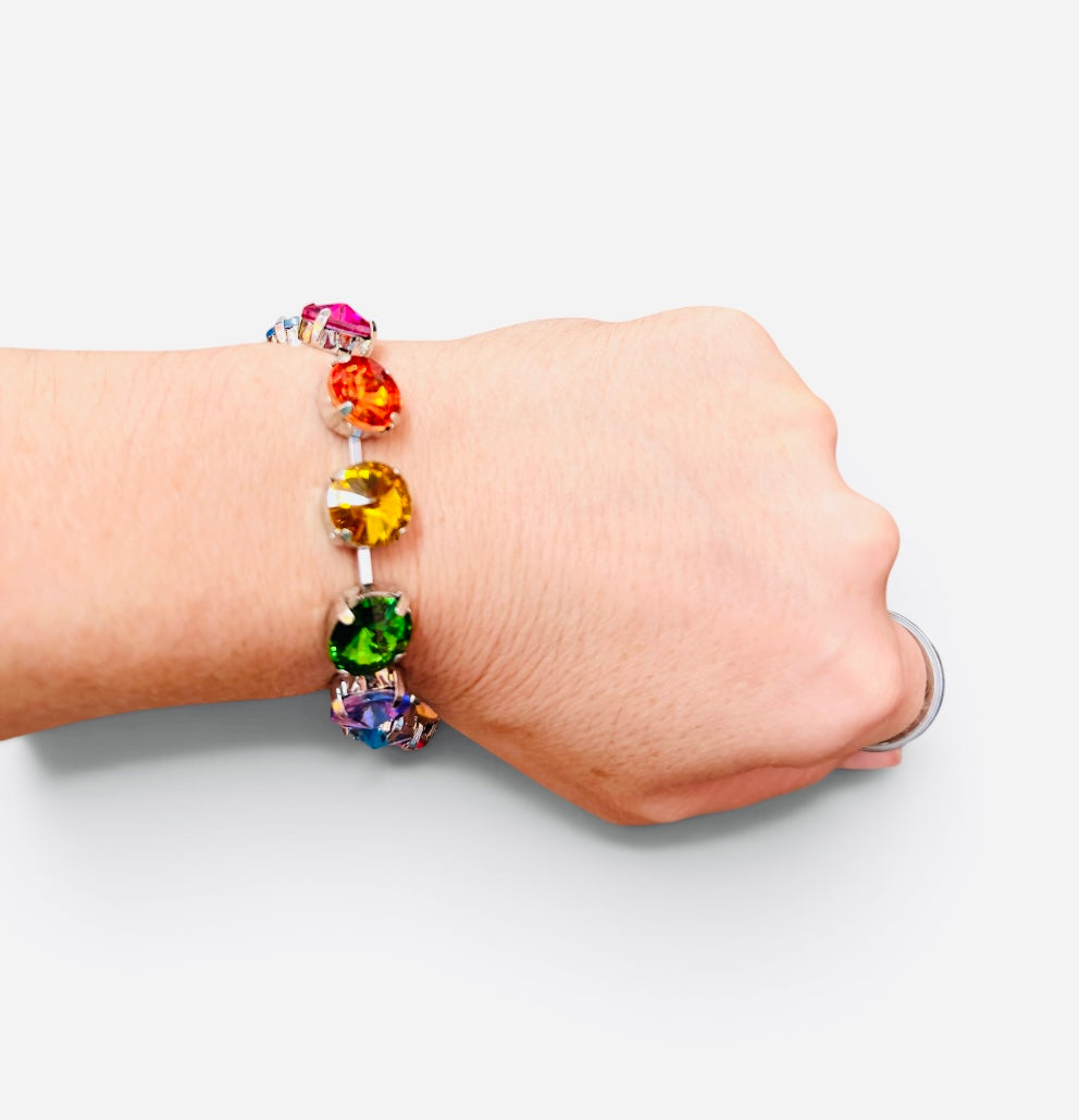 Multicolor bracelet with oversized faceted crystals in pink, orange, yellow, green, blue, and purple.