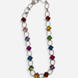Silver-tone chain necklace with multicolor square crystal accents.