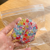 Multicolored translucent bead cluster squishy toy with a geometric bubble design.