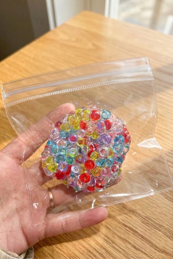 Multicolored translucent bead cluster squishy toy with a geometric bubble design.