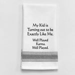 White tea towel with black trim and funny parenting karma quote.