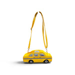 Bright yellow NYC taxi crossbody bag with checkerboard details, wheels, and iridescent windows.