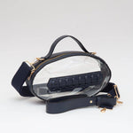 Navy football-shaped vegan leather crossbody bag with gold hardware, top handle, and adjustable strap.