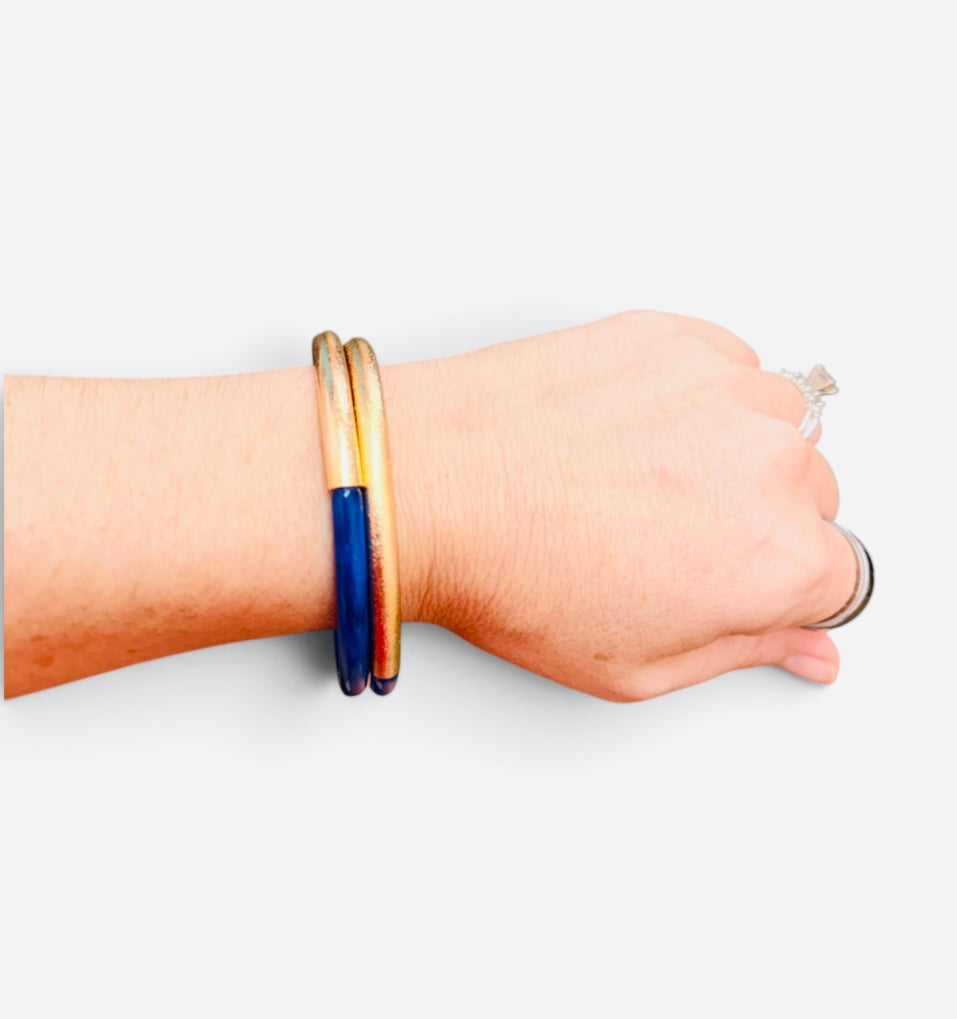 Navy enamel bracelet with textured brushed gold-tone finish and easy slip-on design.