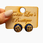 Navy and gold filigree stud earrings with elegant cutout detailing.