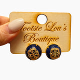 Navy and gold filigree stud earrings with elegant cutout detailing.