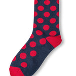 Navy polka dot socks with red heel and toe accents.