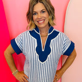 Navy pinstripe top with royal blue scalloped collar and split neckline.